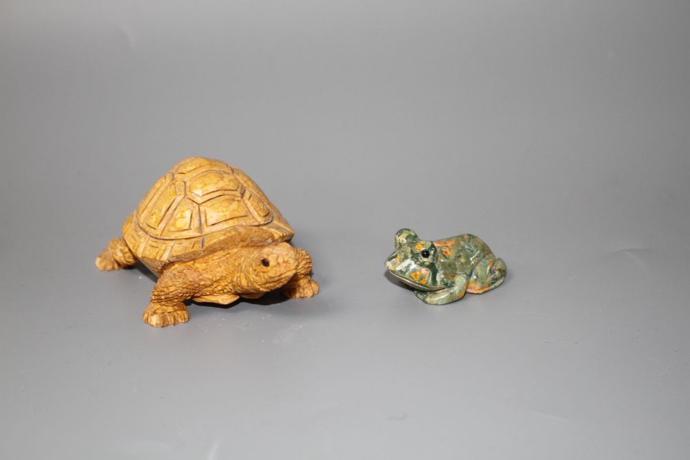 A carved fossil stone tortoise, 8cm and a carved Rhiolite carving of a frog, 4cm